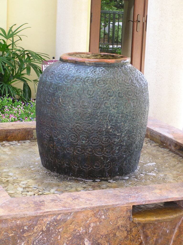 stone outdoor water fountains with a Faux African manmade large tall pot.