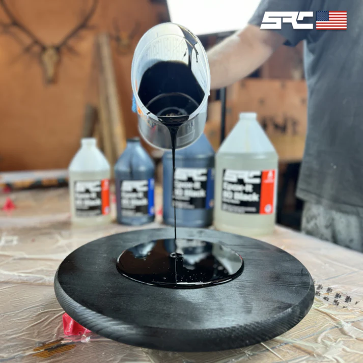 A beginner's guide for 6 resins black epoxy being poured over a table top